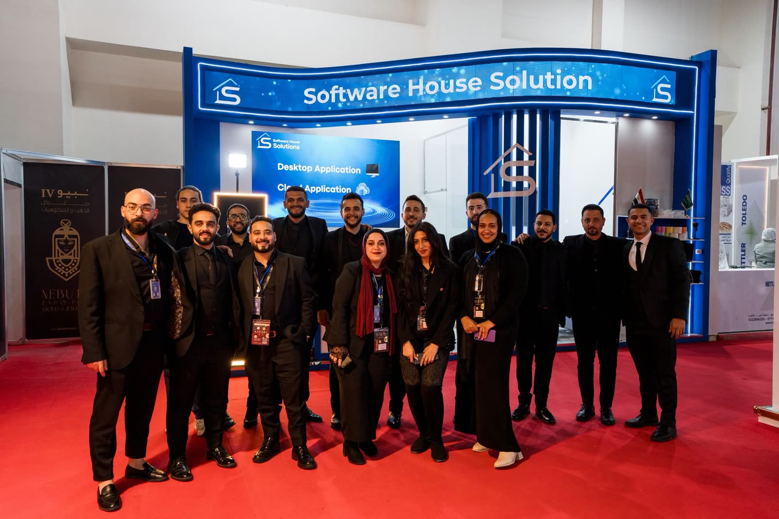 The full Software House Solutions team under the company sign at NEBU Expo 2024.